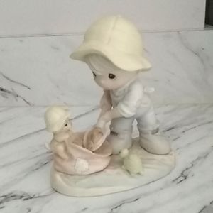 Precious Moments nothing can dampen the spirit of caring statue.